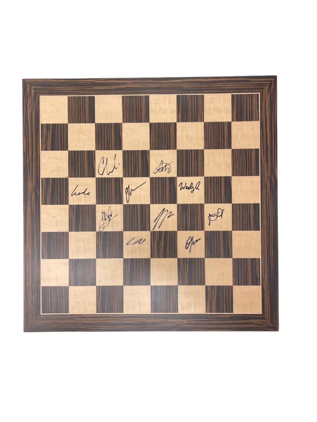 Image of zebra wood board autographed by the players in the 2025 Rapid & Blitz Tournament 