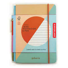 Load image into Gallery viewer, This image shows is the "Lined Mini Notebook &amp; Pen" set from the Inkerie collection, featuring a compact diary bound in soft pastel shades of cream, teal, and soft peach color-blocking. The book is securely wrapped by a wide cream cardboard bellyband highlighting an orange and white circular design, and it includes a vibrant orange elastic strap holding a matching slim pen neatly along its side.
