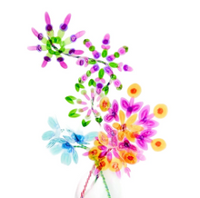 Load image into Gallery viewer, a vibrant bouquet of handmade, translucent plastic flowers tied together on thin, twisted wire stems is shown. The delicate blossoms feature layered geometric petals in glass-like shades of magenta, lime green, bright orange, and sky blue that catch and transmit the light. 
