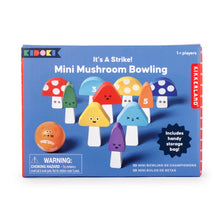 Load image into Gallery viewer, "Mini Mushroom Bowling" game, presented in a bright blue box with playful white text that reads "It's A Strike!" at the top. The box features an illustration of the game pieces arranged on a dark blue surface, displaying a round orange bowling ball with a cartoon face alongside nine colorful, mushroom-shaped wooden pins featuring various cute facial expressions and numbers.
