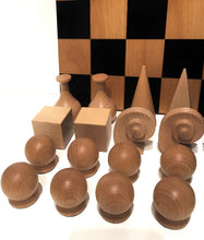 Load image into Gallery viewer, A close-up view of natural wooden chess pieces in abstract geometric shapes displayed in front of a checkered board.
