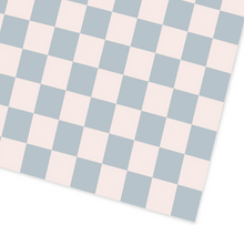 Load image into Gallery viewer, This image shows a close-up, top-down view of a flat sheet of wrapping paper featuring a large checkered pattern. The pattern consists of alternating squares of soft cream and light dusty-blue, which are laid out at a slight diagonal angle across the frame.
