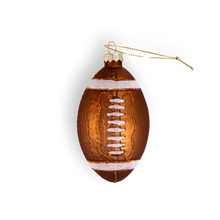 Load image into Gallery viewer, A classic football-shaped glass ornament featuring a metallic brown body, white glittered end stripes, and detailed white laces.
