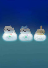 Load image into Gallery viewer, This image showcases three adorable, small night lights featuring popular cartoon characters—a white bear-like creature, a blue-capped cat, and a yellow rabbit—peacefully sleeping on fluffy white clouds. The entire base of each figure emits a soft, gentle glow, with tiny colored stars accenting the front of the clouds against a deep blue background.
