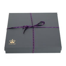Load image into Gallery viewer, A large, dark grey square gift box tied with a thin purple ribbon bow, featuring a gold crown logo and the word "PURLING" printed in the lower-left corner against a white background
