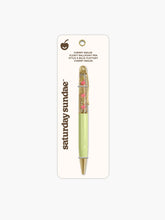 Load image into Gallery viewer, "Saturday Sundae Cherry Smiles Floaty Ballpoint Pen" features a soft pastel lime-green lower barrel, polished gold trim at the tip and clip, and a clear upper half filled with sparkling gold glitter fluid where small pink cherry icons float up and down.
