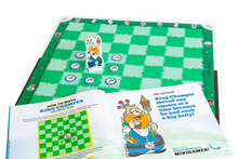 Load image into Gallery viewer, An open instruction storybook alongside a green checkered board with a King character piece and pizza tokens placed on it.
