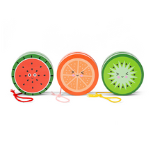 Load image into Gallery viewer, Three round wooden yoyos are arranged side-by-side, each painted to look like a smiling fruit slice. From left to right, the designs depict a red watermelon slice with black seeds, an orange slice, and a light green kiwi fruit, each with its own color-coordinated string loop.
