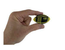 Load image into Gallery viewer, An adult hand lightly pinching a tiny Nerf Weather Blitz football between its thumb and index finger against a white background. The miniature toy features a black body with bright yellow textured grip lines and a yellow "NERF" logo on the side.
