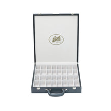 Load image into Gallery viewer, A front-facing view of an open gray chess carrying case with white padded grid slots designed to safely hold chessmen.
