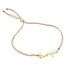 Load image into Gallery viewer, This image shows the unboxed "Scorpio" bracelet arranged in a loose loop against a plain white background. The delicate cursive gold nameplate rests at the bottom, while the double-strand tan cord threads through a tiny, metallic gold star-shaped slider at the top to adjust the fit.
