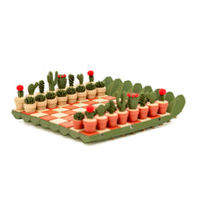 Load image into Gallery viewer, A side-angle view of the fully set up cactus-themed chess set showing the miniature potted succulents aligned on the checkered board.
