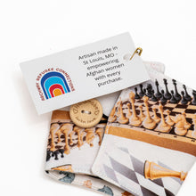 Load image into Gallery viewer, handmade chess themed coffee cozy with wooden button.  The fabric on one side shows a chess board with chess pieces
