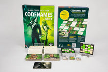 Load image into Gallery viewer, The board game Codenames Duet shown with its main green box and back cover standing upright. Arranged in front are the game components, including stacks of white word cards, green-framed agent tiles, smaller square tokens, and a double-sided grid keycard sitting on a small plastic stand.
