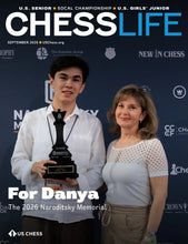 Load image into Gallery viewer, September 2026 cover of Chess Life magazine featuring a young man holding a first-place chess trophy alongside a woman standing next to him.
