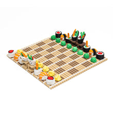 Load image into Gallery viewer, An elevated perspective captures the full sushi chess board set up on a bamboo rolling mat, with white-roll and black-roll sides facing each other.
