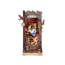 Load image into Gallery viewer, The assembled wooden book nook kit is displayed vertically, styled like a hollowed-out tree trunk framing a whimsical scene of Alice falling down the rabbit hole into Wonderland.
