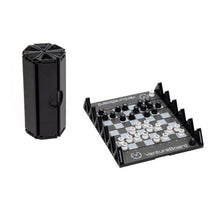 Load image into Gallery viewer, A compact, black foldable Venture Board mini travel chess set shown fully set up with flat, circular black and white pieces on its grid, alongside its octagonal, column-shaped container when folded.
