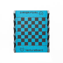 Load image into Gallery viewer, A top-down view of an unfolded VentureBoard mini travel chess set featuring a bright blue-and-grey checkered board with rank and file notation.
