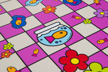 Load image into Gallery viewer, A close-up view of the center of a vinyl chessboard displaying pop-art artwork including a fish in a bowl, colorful flowers, and small stylized fish.
