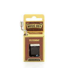Load image into Gallery viewer, This image shows the same small, hand-cranked music box packaging, this time featured in a medium brown and pale yellow cardboard design. A silver metal crank extends up from the top left side, and the front brown panel displays the text "YESTERDAY" directly above the cutout window revealing the internal metal mechanism.

