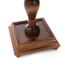Load image into Gallery viewer, A close-up view of the carved, dark wood pedestal base resting on a tiered square foundation with small feet.
