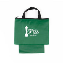 Load image into Gallery viewer, A green zippered chess piece bag with black woven carrying handles and an extended bottom pouch, featuring the white "World Chess Hall of Fame, Saint Louis, MO" logo printed on the front.

