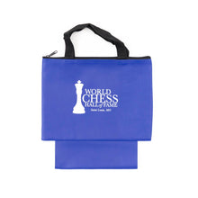 Load image into Gallery viewer, A royal blue zippered chess piece bag with black woven carrying handles and an extended bottom pouch, featuring the white "World Chess Hall of Fame, Saint Louis, MO" logo printed on the front.
