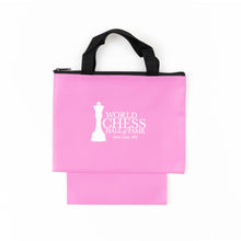 Load image into Gallery viewer, A pink zippered chess piece bag with black woven carrying handles and an extended bottom pouch, featuring the white "World Chess Hall of Fame, Saint Louis, MO" logo printed on the front.
