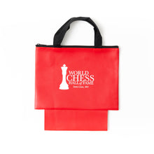 Load image into Gallery viewer, A red zippered chess piece bag with black woven carrying handles and an extended bottom pouch, featuring the white "World Chess Hall of Fame, Saint Louis, MO" logo printed on the front.
