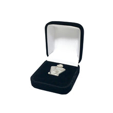 Load image into Gallery viewer, The pin rests on a black velvet insert inside a small, black hinged presentation box with a rounded rectangular frame. The interior lid is lined with smooth white satin fabric.
